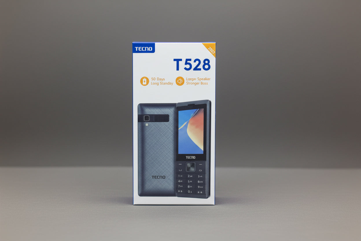 Hand holding a TECNO T528 phone packaging against a gray background